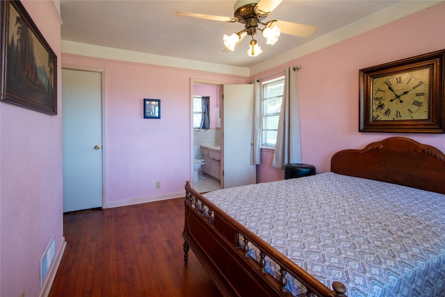 bedroom featuring dark wood-type flooring, ensuite bathroom, and ceiling fan