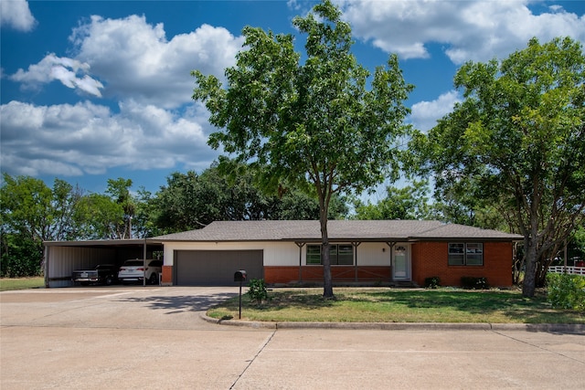 single story home with a garage, a front yard, and a carport