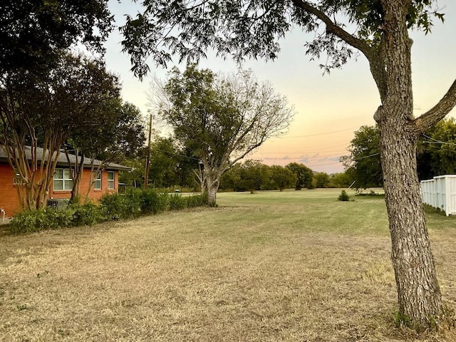 view of yard at dusk