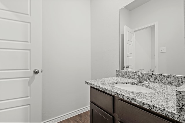 bathroom with vanity and hardwood / wood-style floors