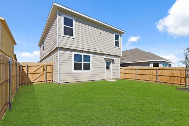 rear view of property featuring a yard