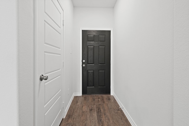 doorway with dark hardwood / wood-style flooring