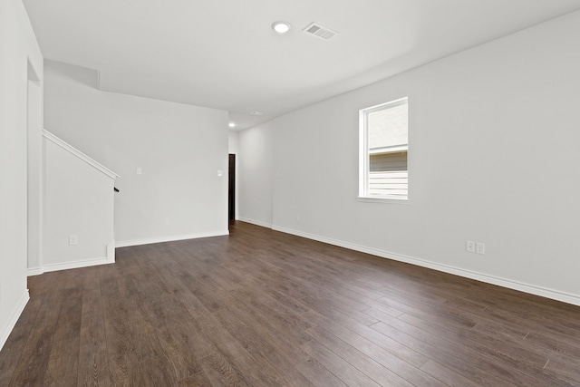 spare room with dark hardwood / wood-style flooring