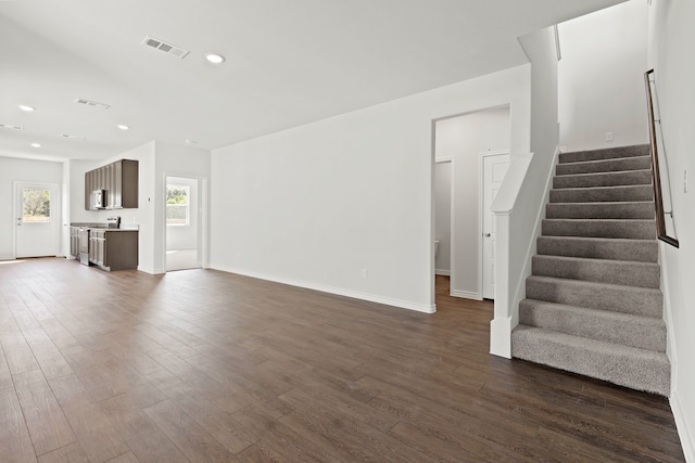 unfurnished living room featuring dark hardwood / wood-style floors