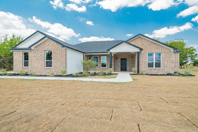 view of front of home with a porch and a front yard