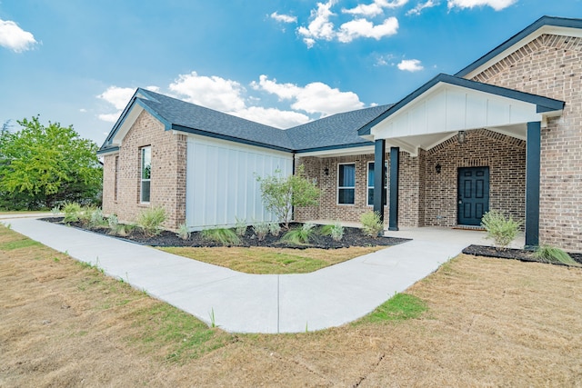 view of front of home with a front yard and a porch