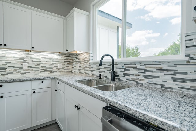 kitchen featuring white cabinetry, sink, and a wealth of natural light