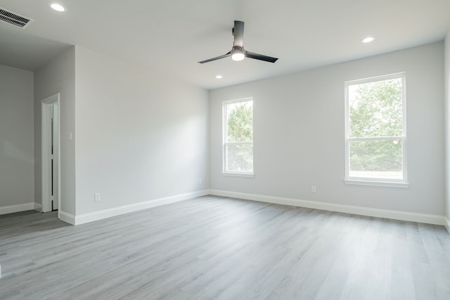 spare room featuring light hardwood / wood-style flooring and ceiling fan