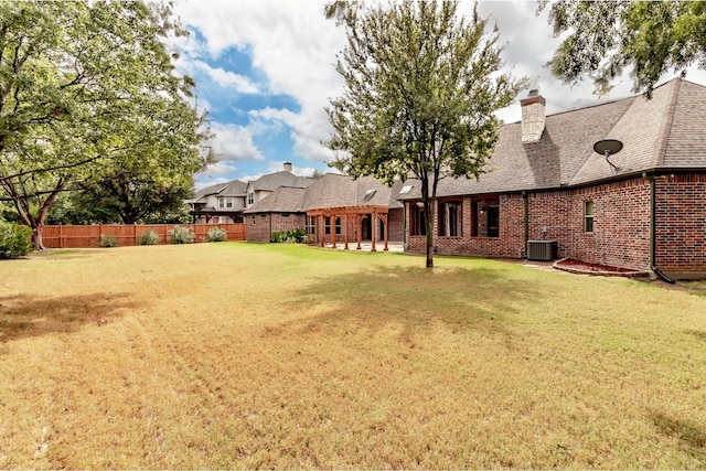 view of yard featuring central air condition unit, fence, and a pergola