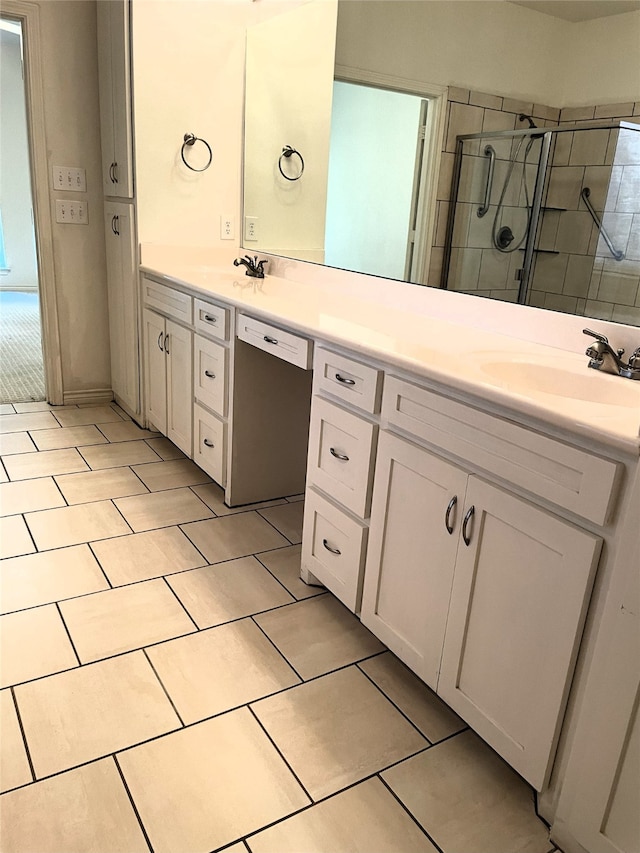 bathroom featuring vanity and an enclosed shower