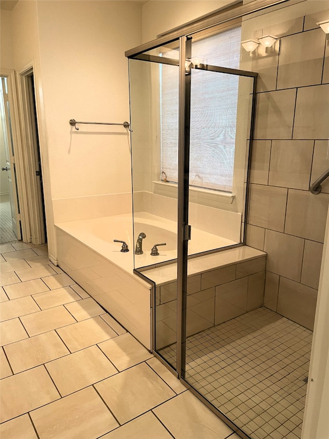 bathroom featuring tile patterned flooring and separate shower and tub