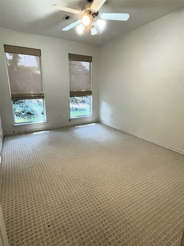 spare room with ceiling fan and carpet floors