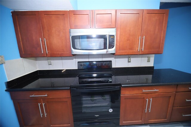 kitchen featuring black electric range oven, dark stone counters, and decorative backsplash