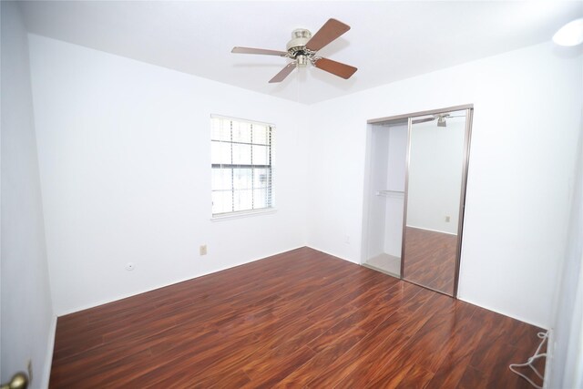 unfurnished bedroom with hardwood / wood-style flooring, a closet, and ceiling fan