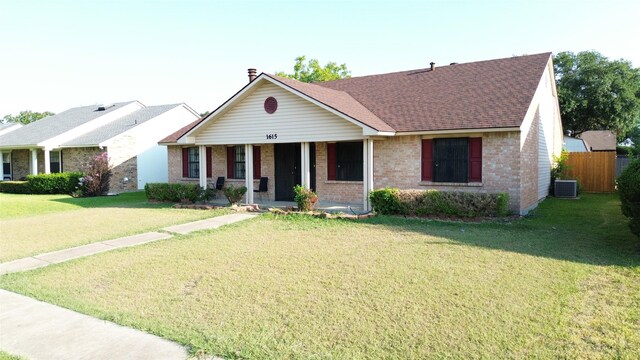 single story home with a porch, cooling unit, and a front yard