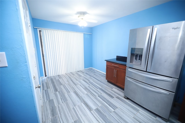 kitchen featuring ceiling fan and stainless steel fridge with ice dispenser