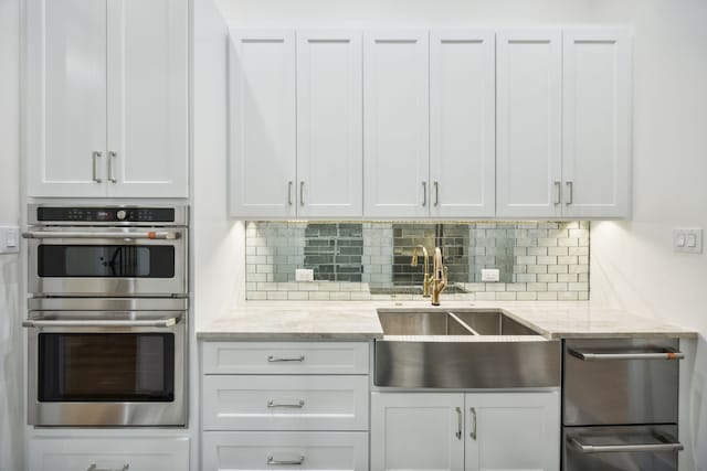 kitchen with white cabinets and stainless steel double oven