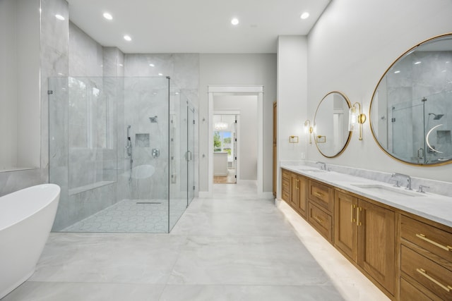 bathroom featuring vanity and shower with separate bathtub