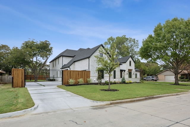 view of front of property with a front lawn and a garage