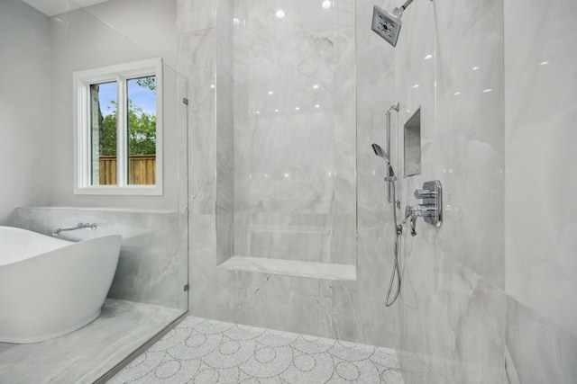 bathroom with tile walls, independent shower and bath, and tile patterned floors