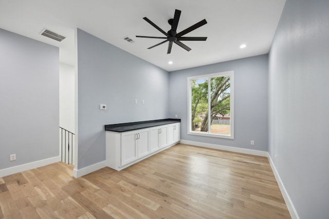 empty room featuring ceiling fan and light wood-type flooring