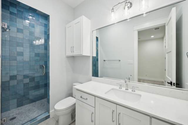 bathroom featuring vanity, toilet, and an enclosed shower