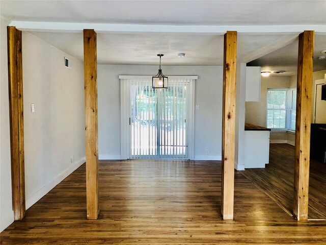 unfurnished room with dark wood-type flooring