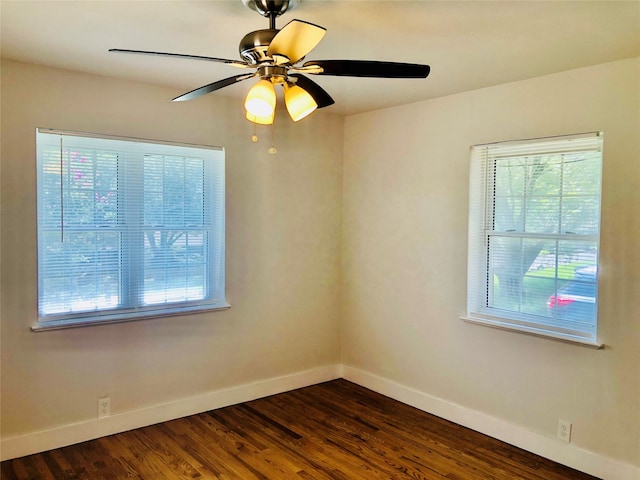 empty room with dark wood-type flooring and ceiling fan