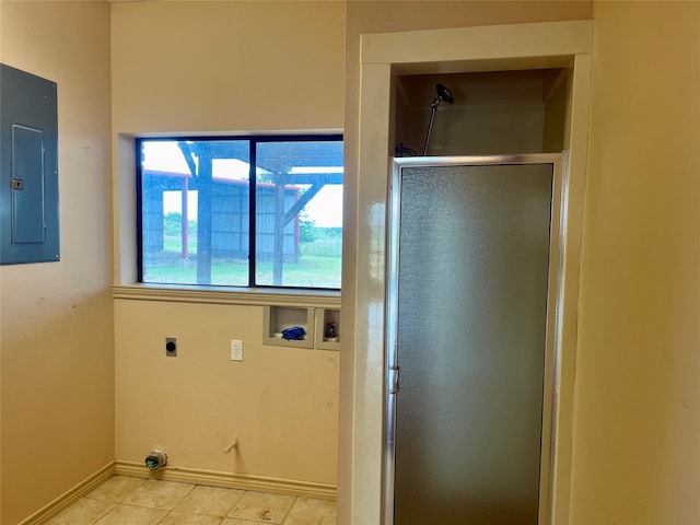 washroom with electric dryer hookup, hookup for a washing machine, light tile patterned floors, and electric panel