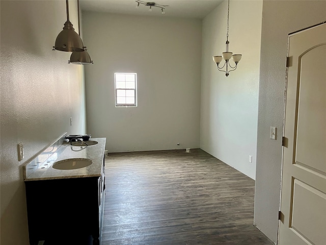 bathroom with wood-type flooring and track lighting