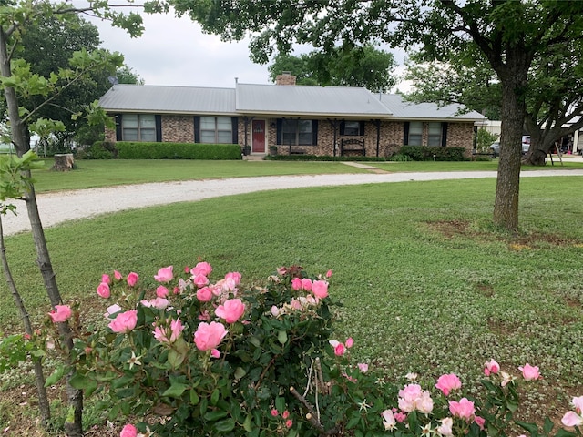 ranch-style home featuring a front yard