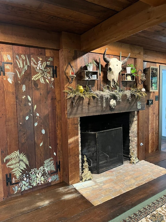 interior details with wood-type flooring, a stone fireplace, and wood walls