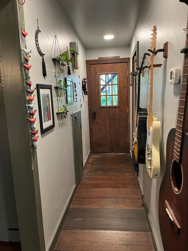 entryway with dark hardwood / wood-style flooring