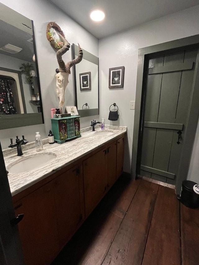 bathroom with vanity and wood-type flooring