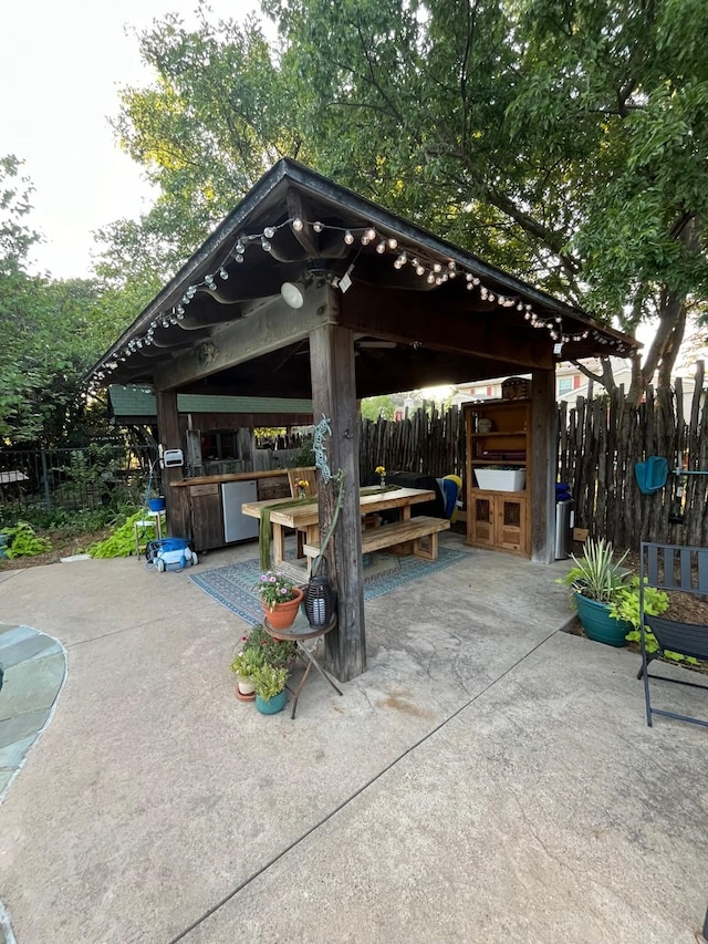 view of patio / terrace featuring a gazebo and a bar