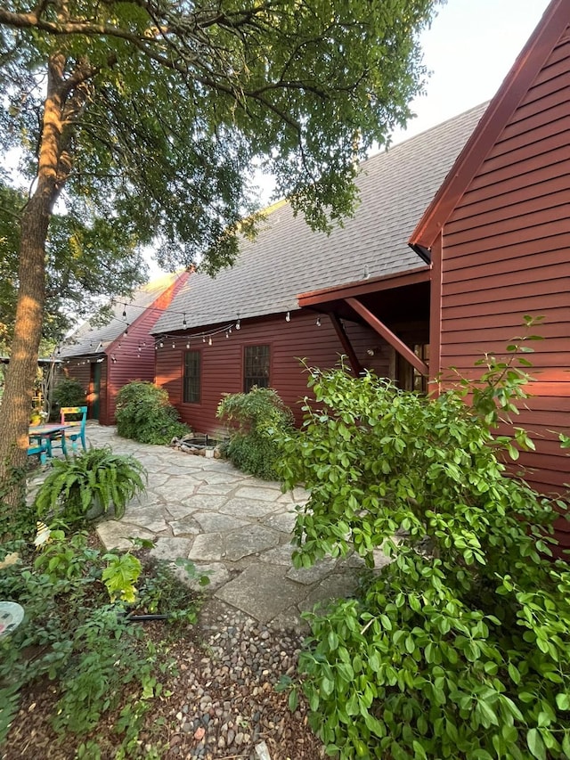 view of side of property with a patio