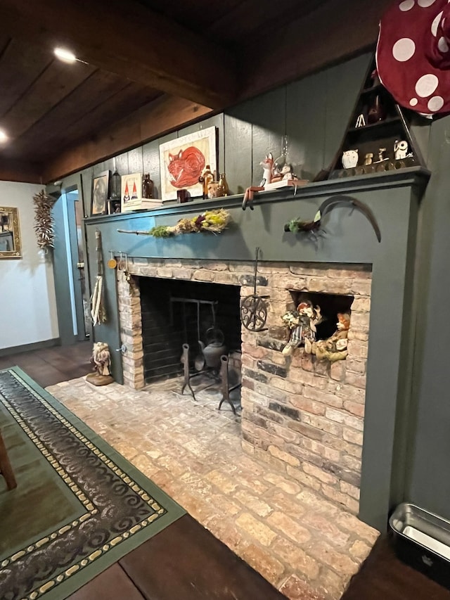 interior details with beamed ceiling and a fireplace