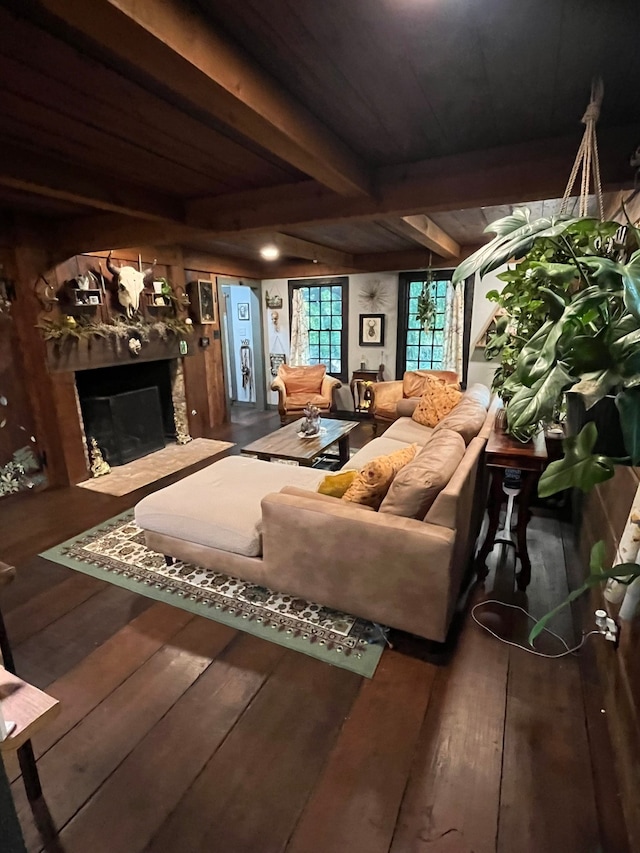 living room featuring hardwood / wood-style flooring, beamed ceiling, and a high end fireplace