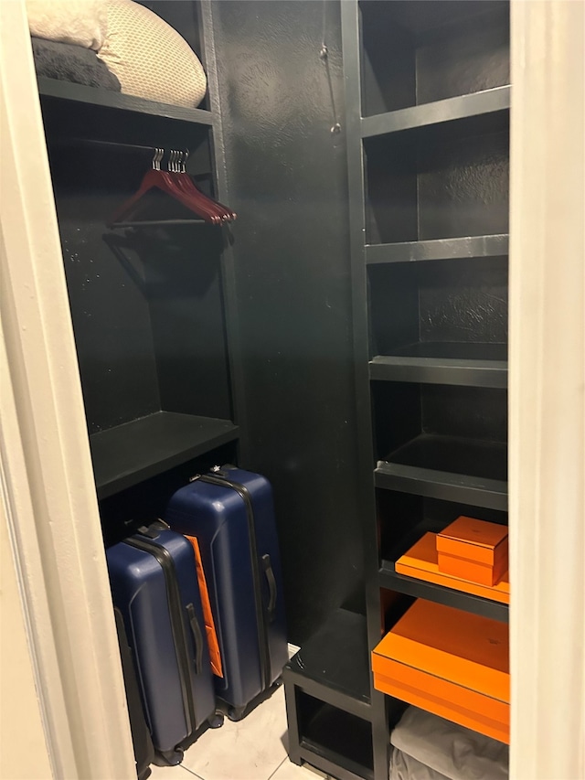 spacious closet with light tile patterned floors