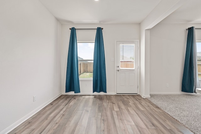 unfurnished room with light wood-type flooring