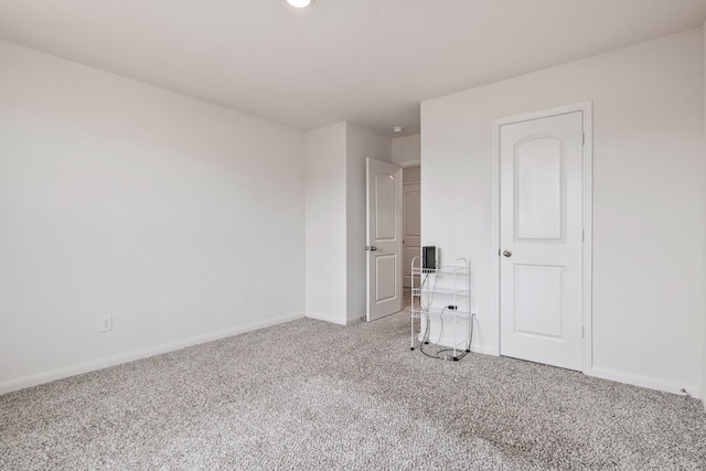 unfurnished bedroom featuring carpet flooring and a closet