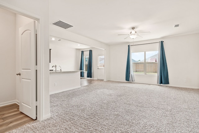 empty room featuring ceiling fan and light hardwood / wood-style floors