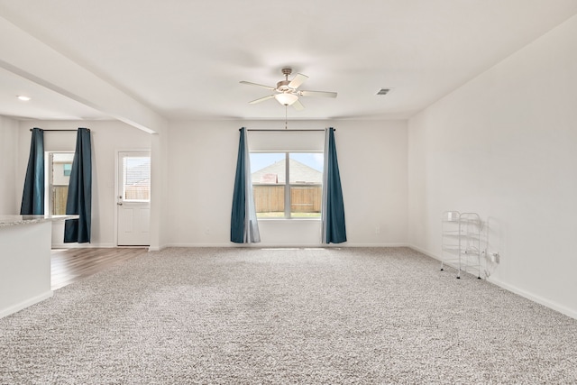 carpeted empty room featuring ceiling fan