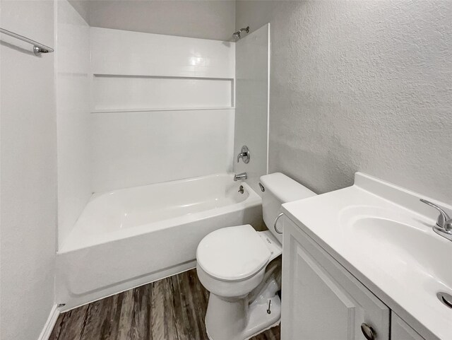 full bathroom featuring shower / bath combination, wood-type flooring, vanity, and toilet