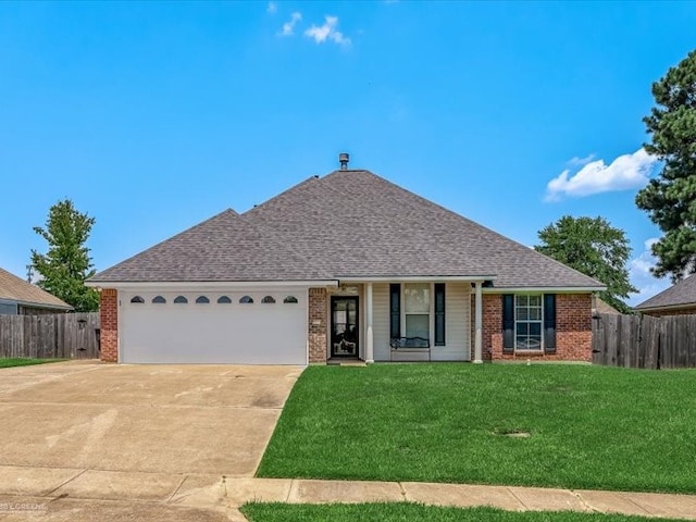 single story home featuring a garage and a front lawn