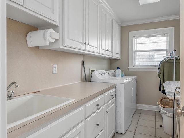 washroom featuring sink, cabinets, washer and dryer, light tile patterned flooring, and ornamental molding