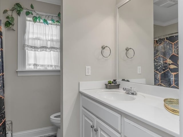 bathroom featuring crown molding, toilet, and vanity