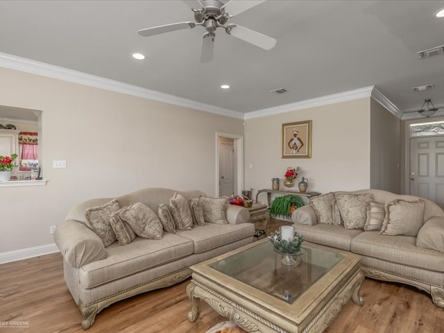 living room featuring light hardwood / wood-style floors, ceiling fan, and crown molding