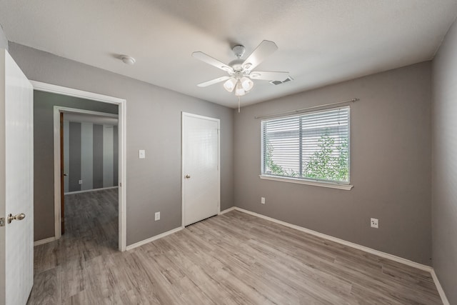 unfurnished bedroom with hardwood / wood-style flooring, a closet, and ceiling fan