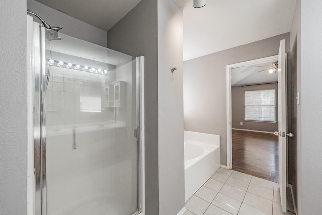 bathroom featuring tile patterned floors and separate shower and tub